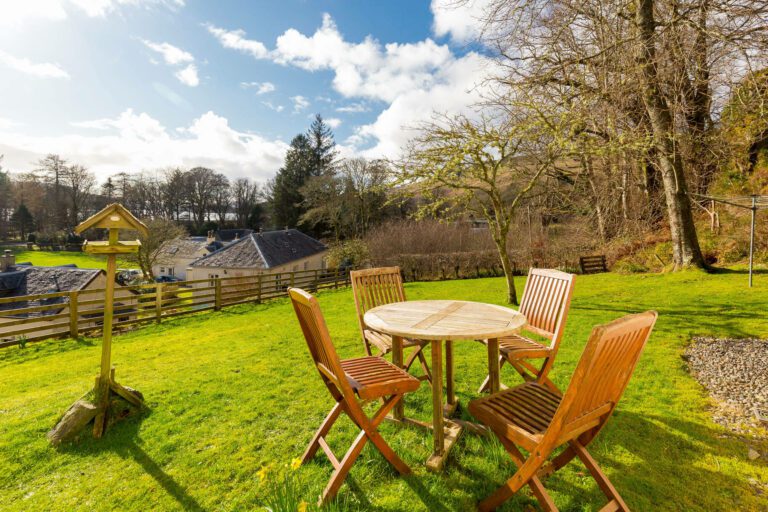 The sunny garden overlooking the inner village from Beechwood House, 4 star luxury self catering cottage at Melfort Village near Oban, Scotland